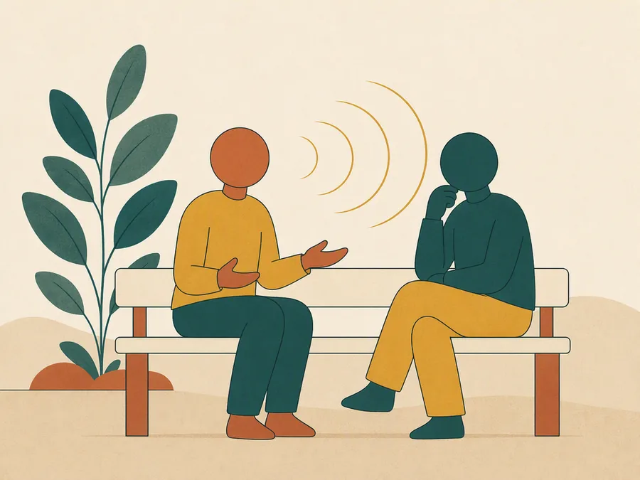 A couple on a bench, one speaking while the other listens properly
